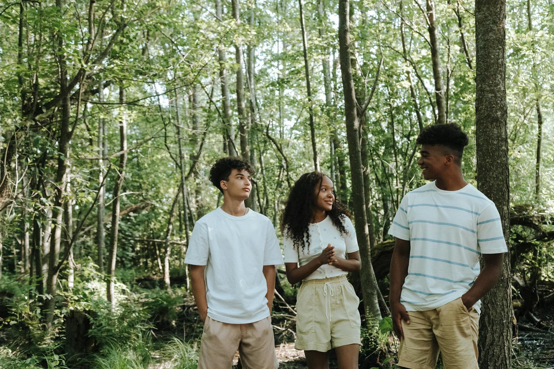 A small group of friends walking together outdoors on a sunny day
