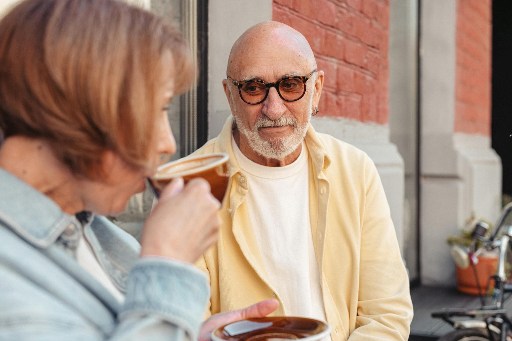 An older couple sharing coffee together outdoors