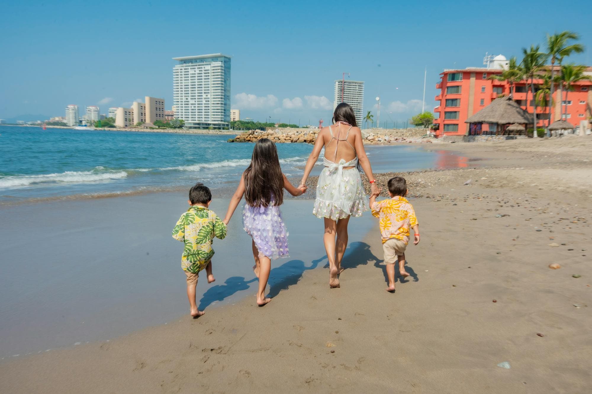 A family walking together on a Puerto Vallarta beach.